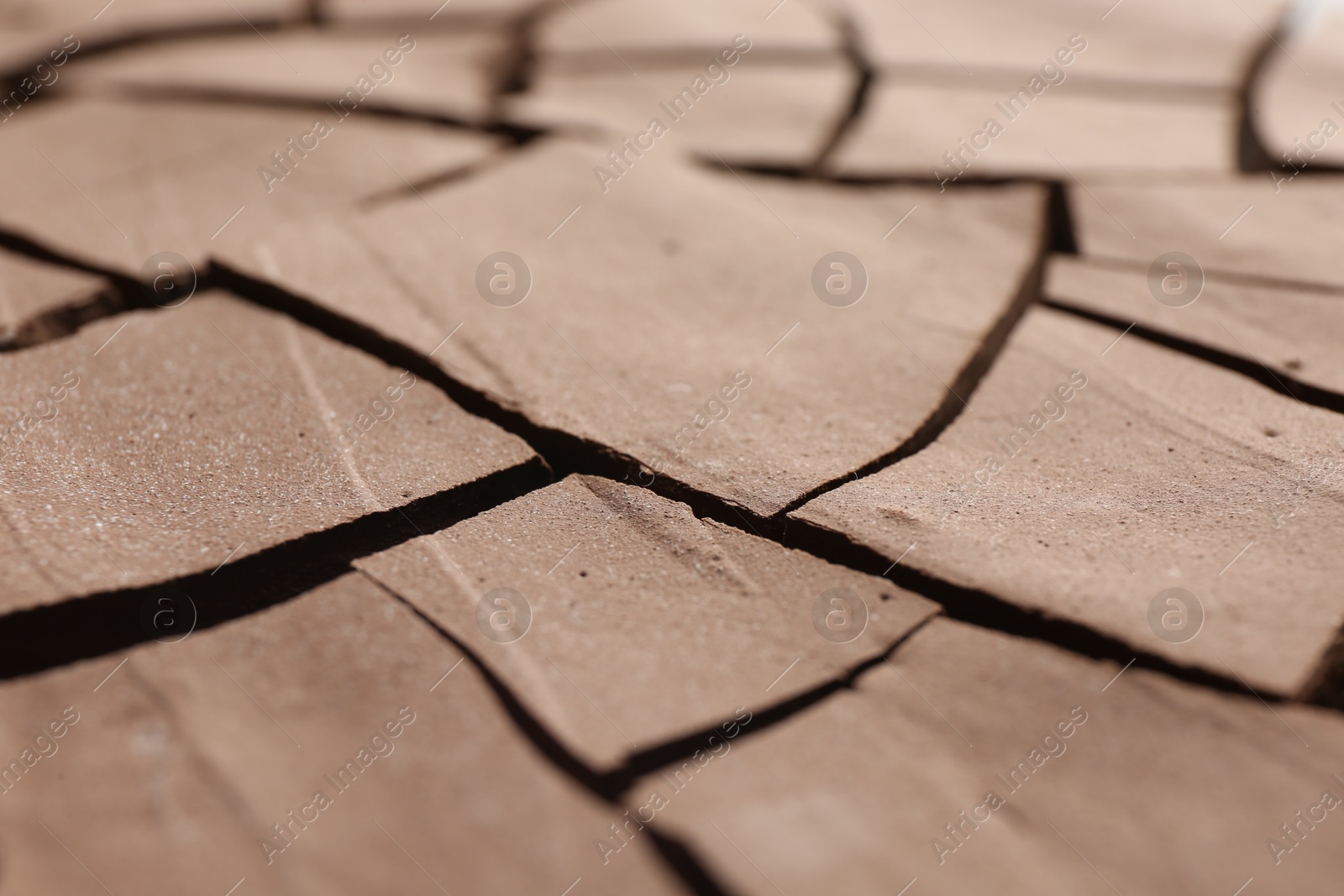 Photo of Dry cracked ground as background, closeup. Global warming