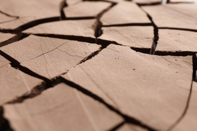 Photo of Dry cracked ground as background, closeup. Global warming