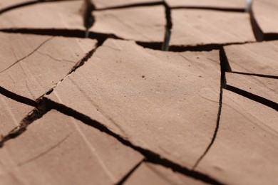 Photo of Dry cracked ground as background, closeup. Global warming