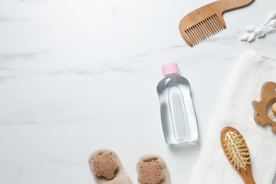 Photo of Baby oil and bath accessories on white marble background, flat lay. Space for text