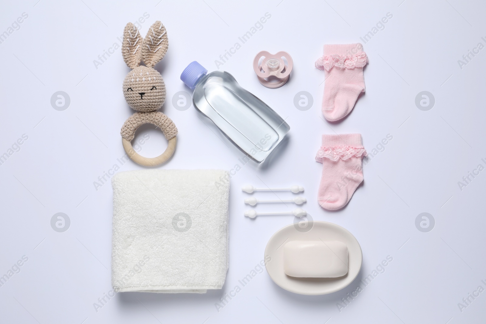 Photo of Baby oil and bath accessories on white background, flat lay