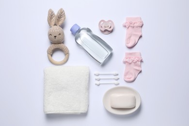 Photo of Baby oil and bath accessories on white background, flat lay