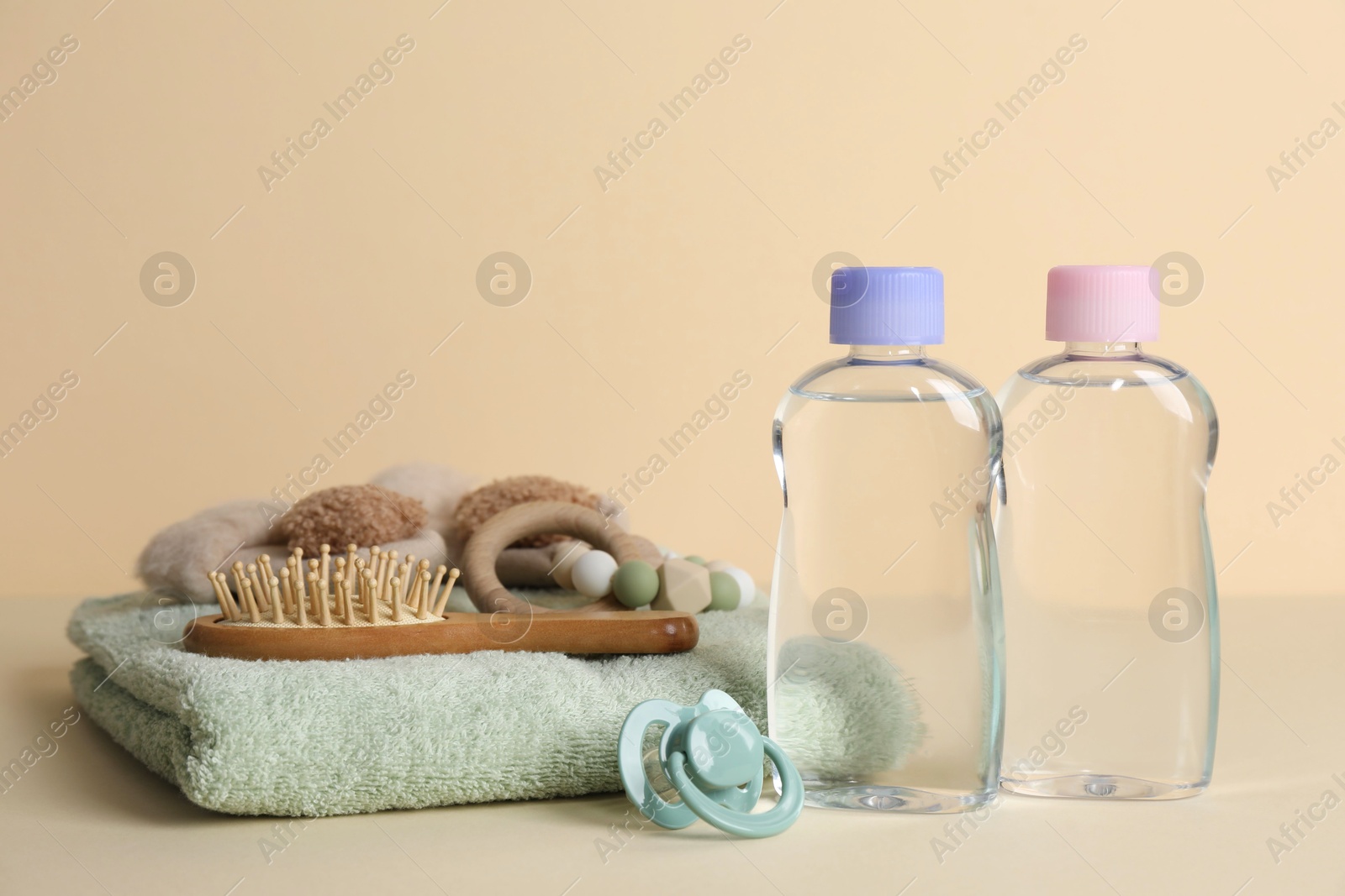 Photo of Baby oil and bath accessories on color background