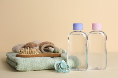 Photo of Baby oil and bath accessories on color background