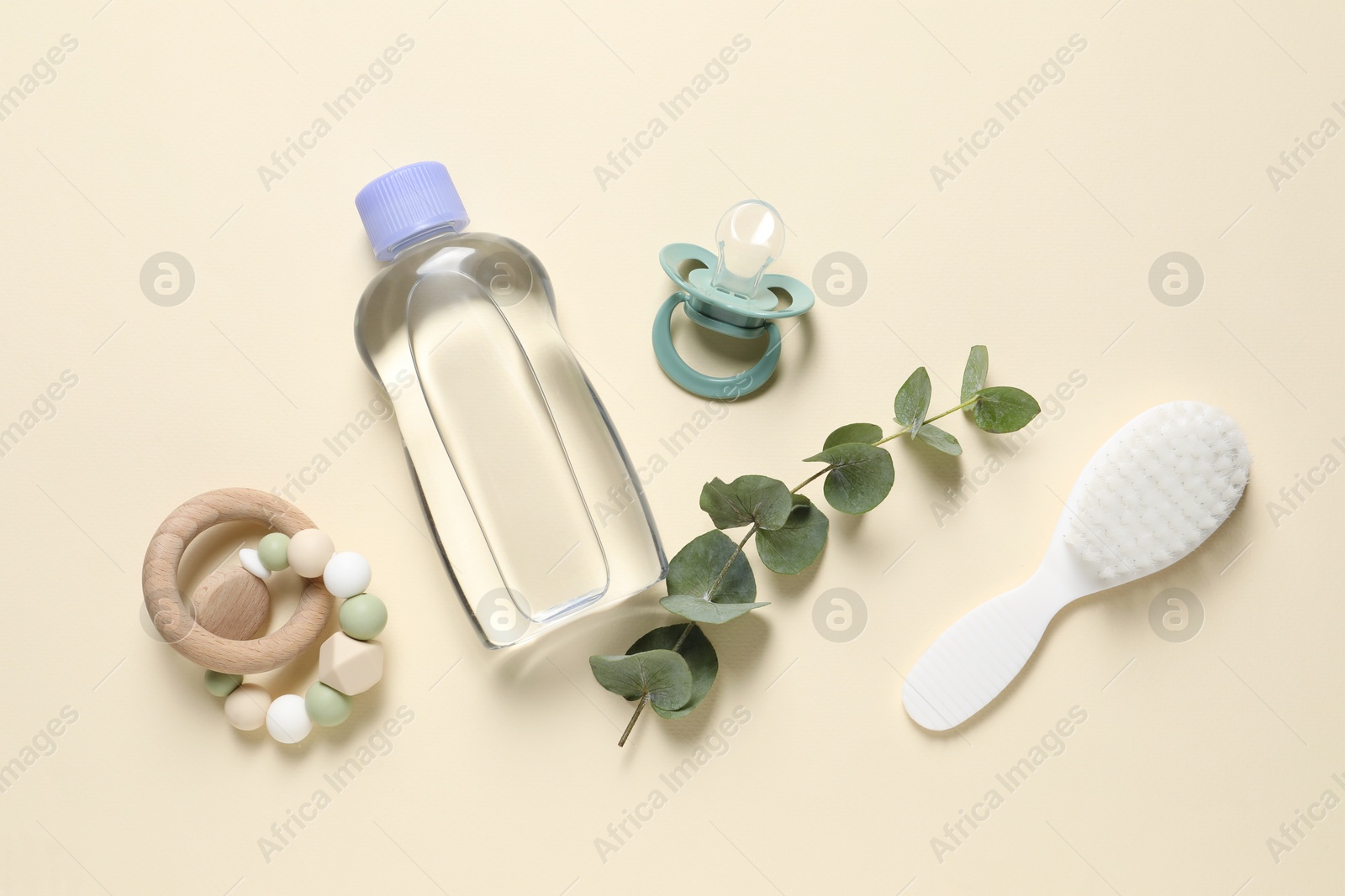 Photo of Baby oil, eucalyptus and accessories on beige background, flat lay