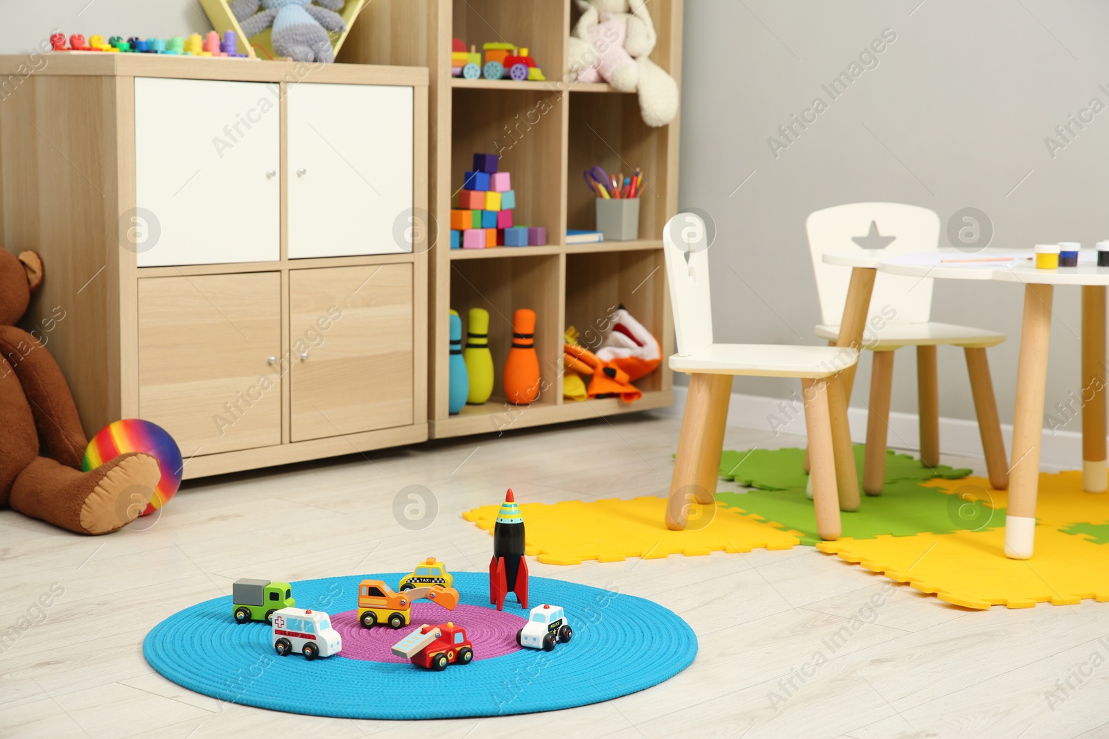 Photo of Beautiful kid's room interior with toys and stylish furniture