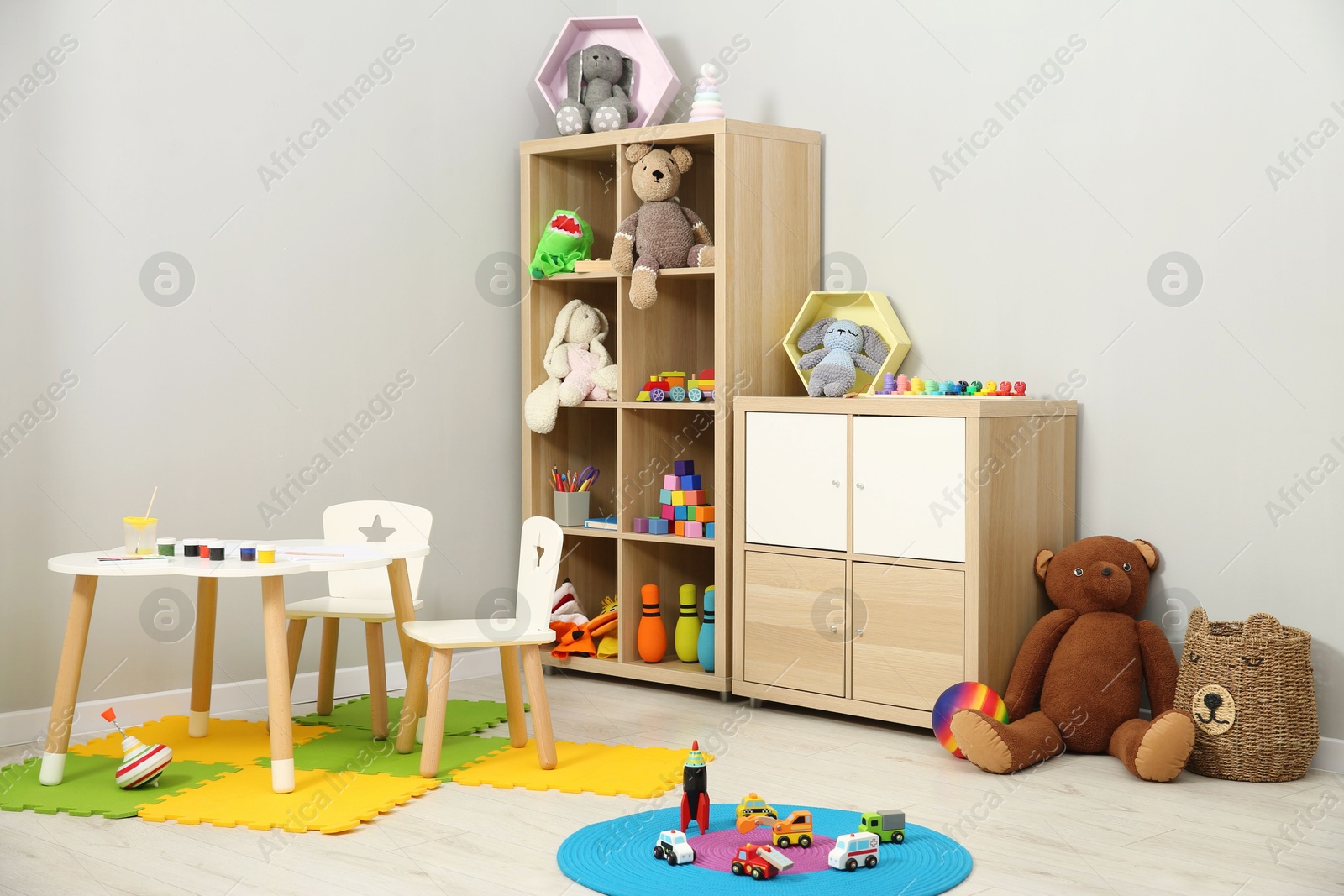 Photo of Beautiful kid's room interior with toys and stylish furniture