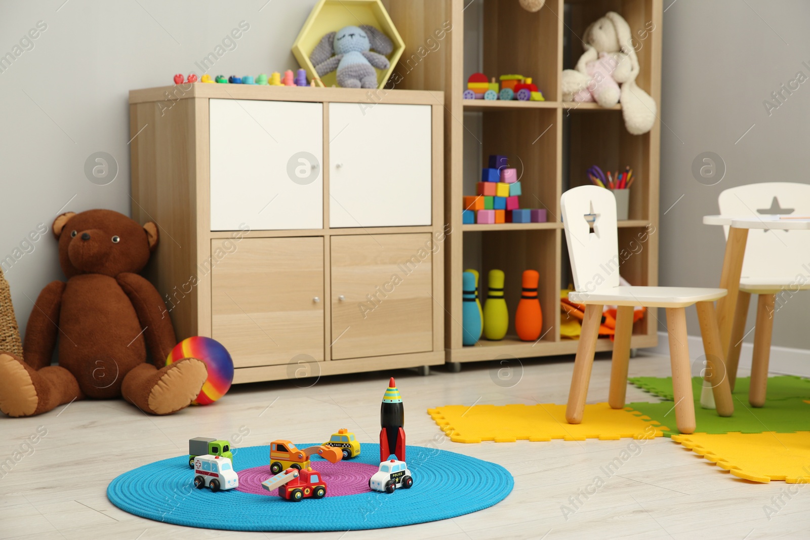 Photo of Beautiful kid's room interior with toys and stylish furniture