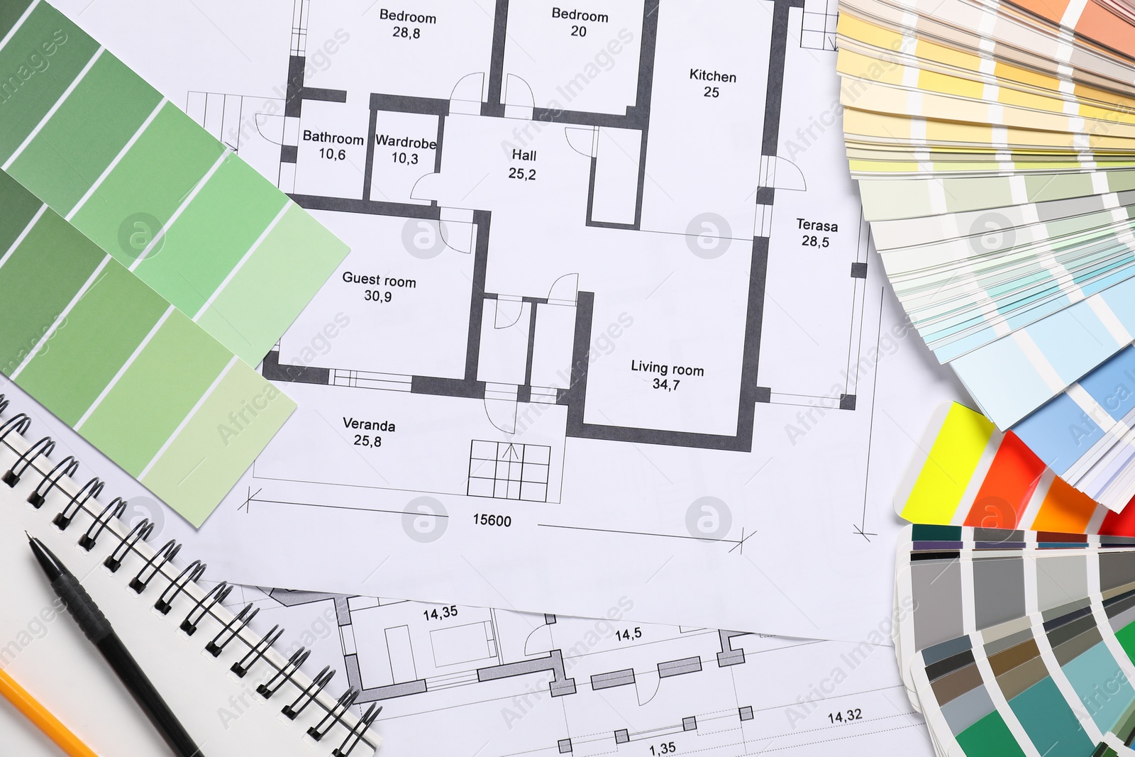 Photo of House plans, color selection charts and notebook on table, flat lay. Decorating and design