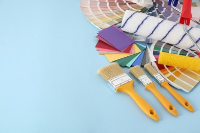 Photo of Different painter's tools on light blue table, space for text. Decorating and design