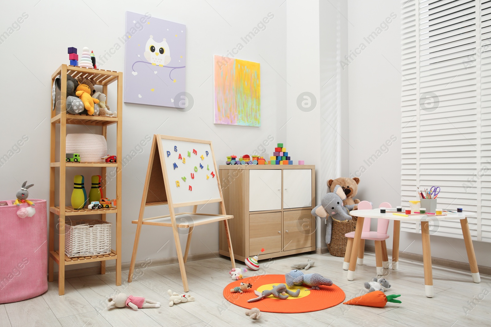 Photo of Table with paints and different toys in child's room