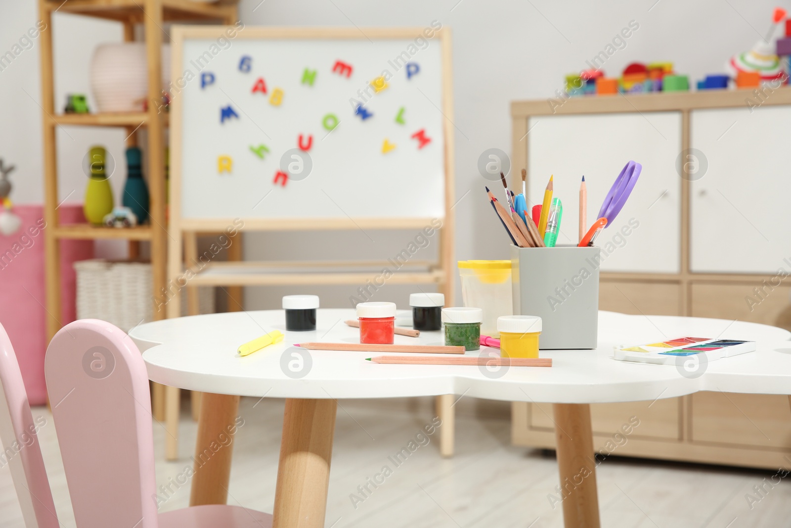 Photo of Table with paints and other stationery in child's room