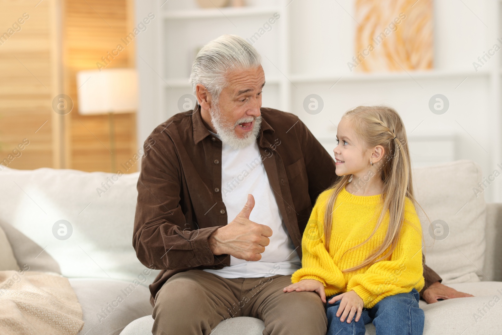 Photo of Grandpa and his granddaughter spending time together at home