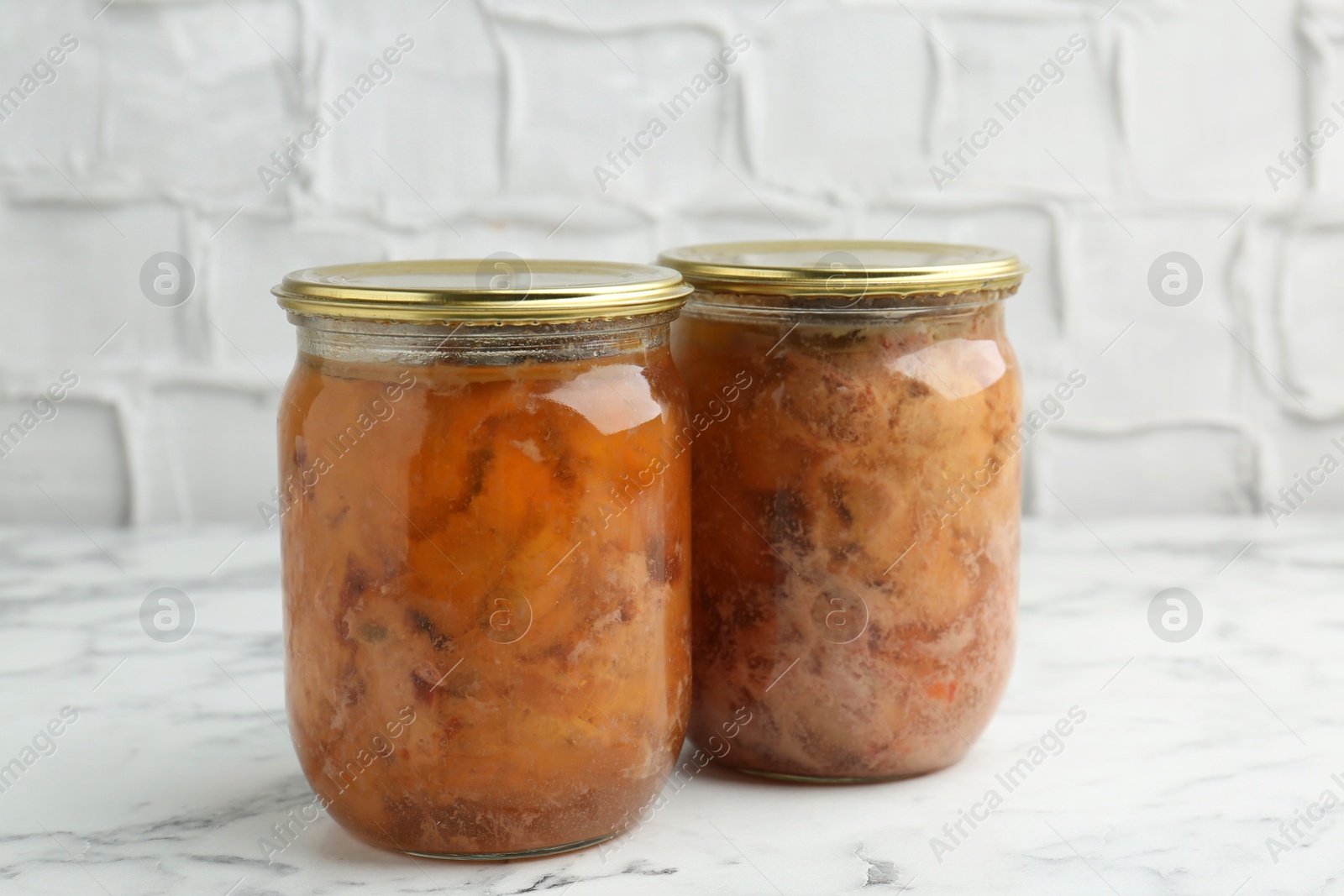 Photo of Canned meat in glass jar on white marble table