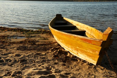 Photo of Wooden boat near river on sunny day