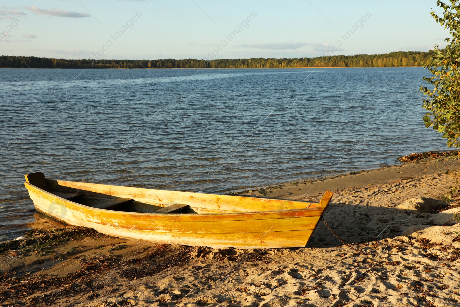 Photo of Wooden boat near river on sunny day