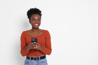 Photo of Happy woman with smartphone on white background. Space for text