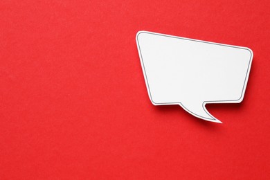 Photo of Blank speech bubble on red background, top view. Space for text