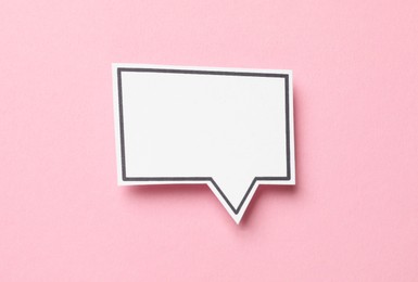 Photo of Blank speech bubble on light pink background, top view. Space for text