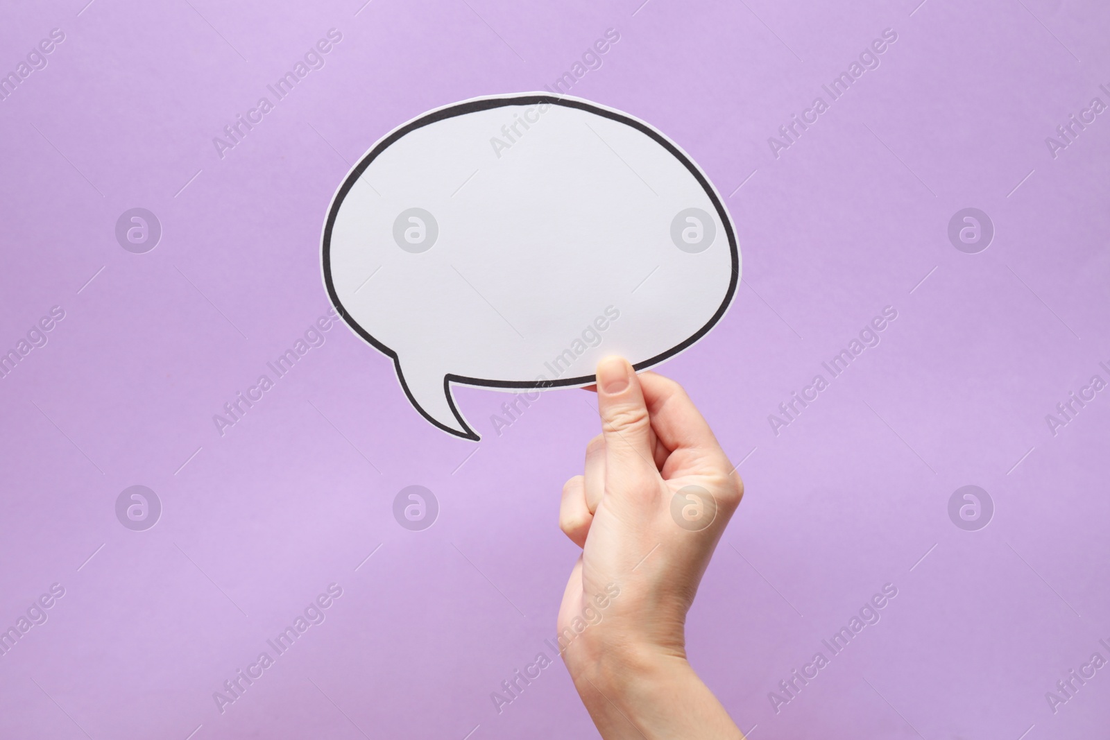 Photo of Woman holding blank speech bubble on lilac background, closeup. Space for text