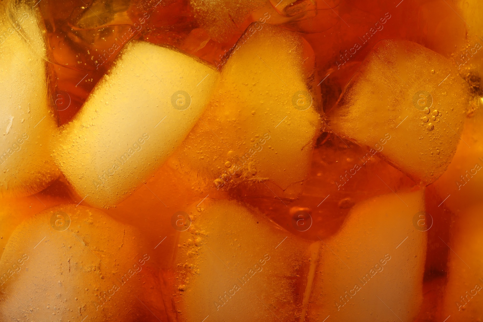 Photo of Refreshing coffee with ice cubes as background, closeup