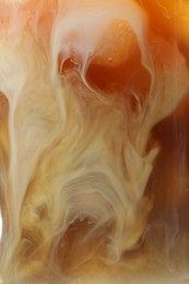 Photo of Refreshing coffee with ice and milk as background, closeup