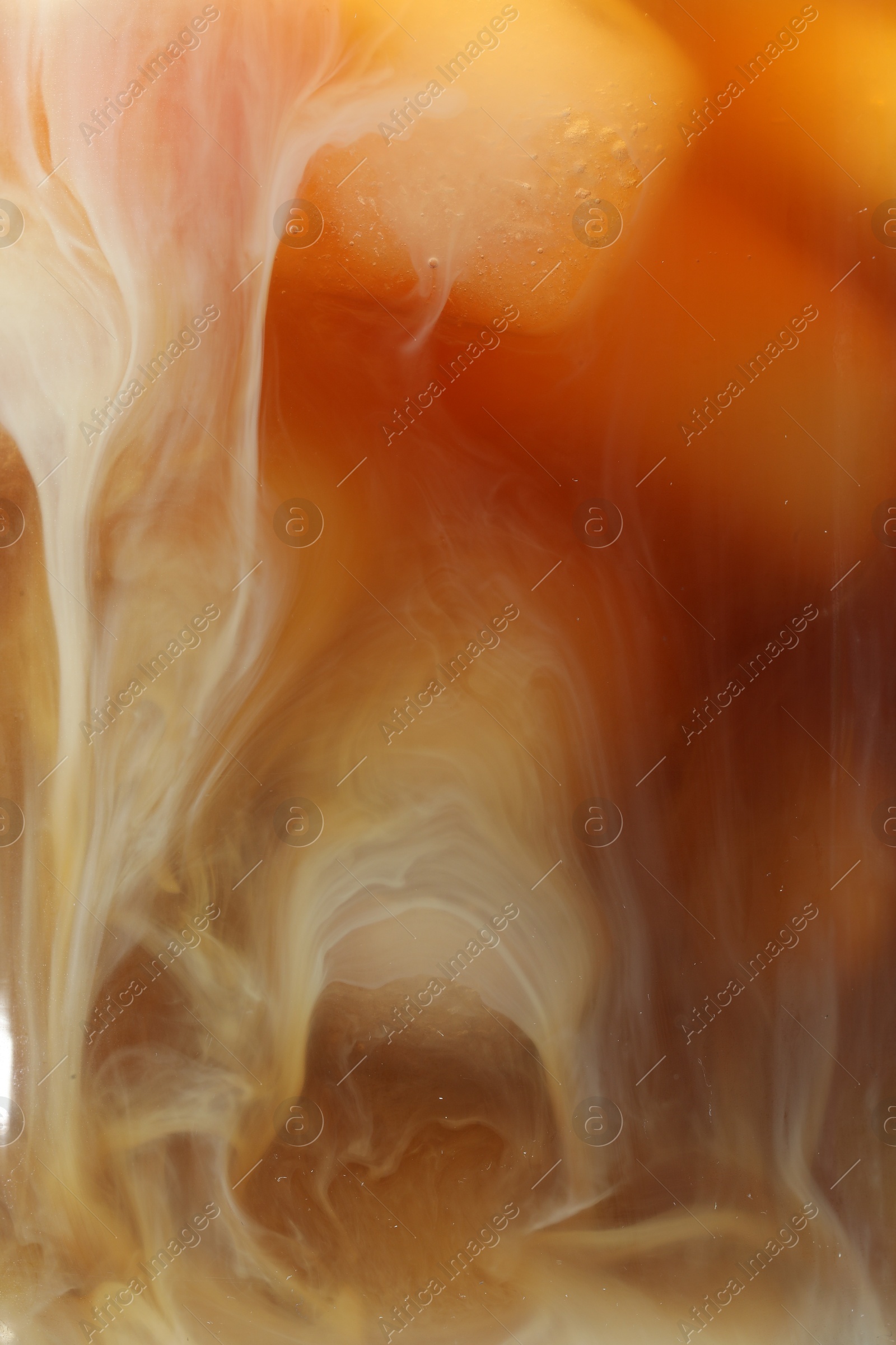 Photo of Refreshing coffee with ice and milk as background, closeup