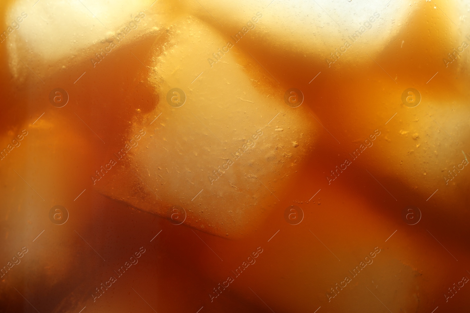 Photo of Refreshing coffee with ice cubes as background, closeup