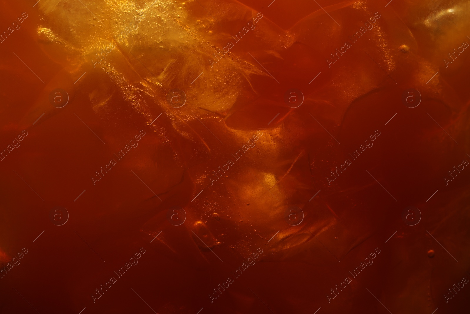 Photo of Refreshing coffee with ice cubes as background, closeup