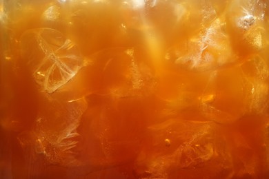 Photo of Refreshing coffee with ice cubes as background, closeup