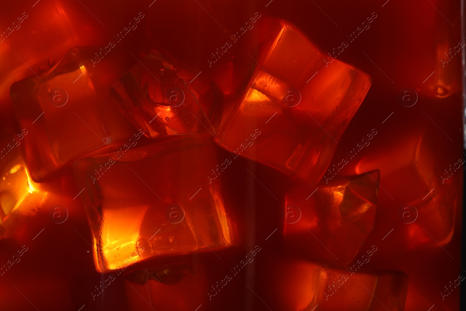 Photo of Refreshing coffee with ice cubes as background, closeup