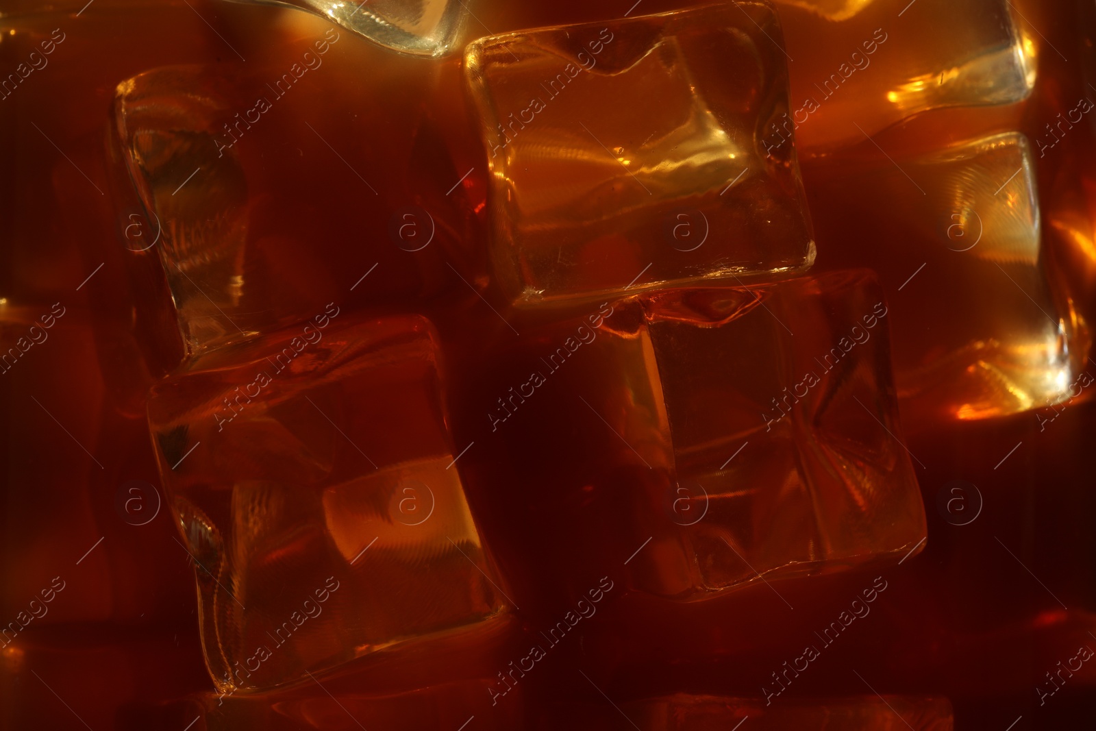 Photo of Refreshing coffee with ice cubes as background, closeup