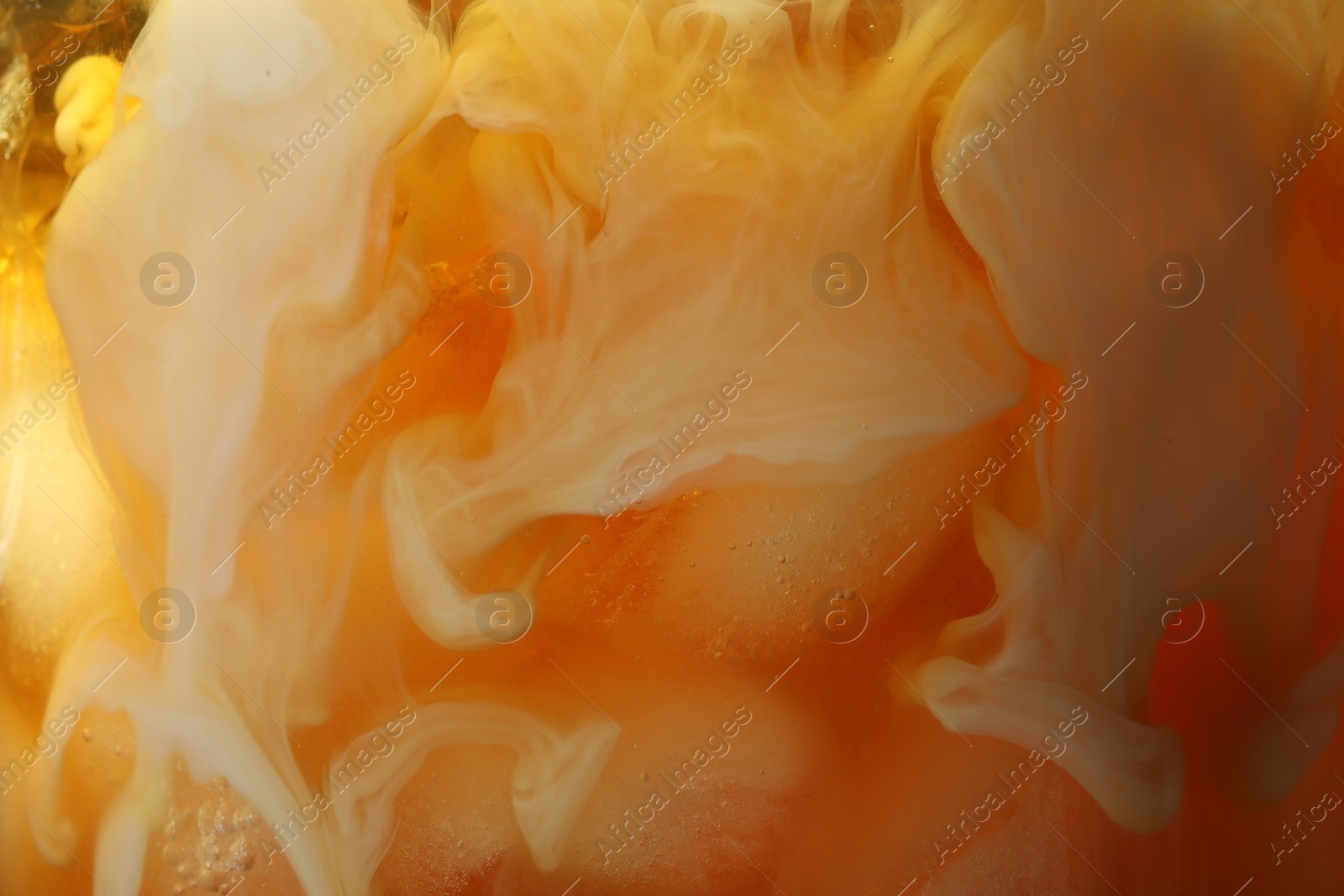 Photo of Refreshing coffee with ice and milk as background, closeup