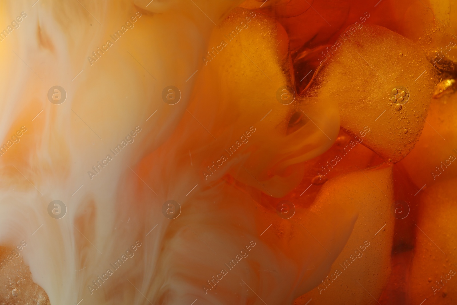 Photo of Refreshing coffee with ice and milk as background, closeup