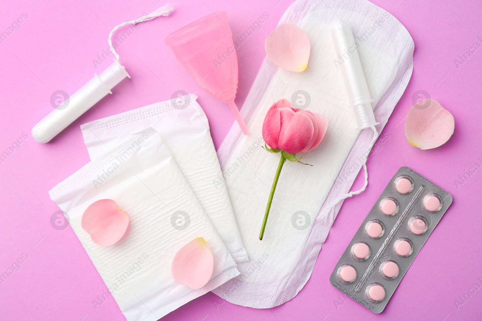 Photo of Flat lay composition with menstrual products on violet background