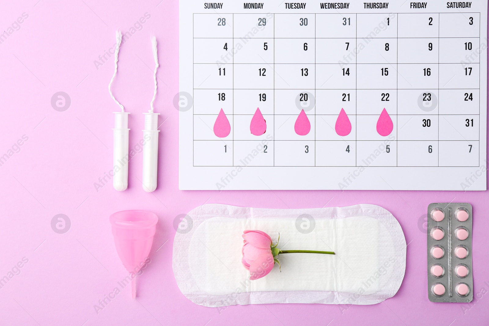 Photo of Flat lay composition with calendar and menstrual products on violet background