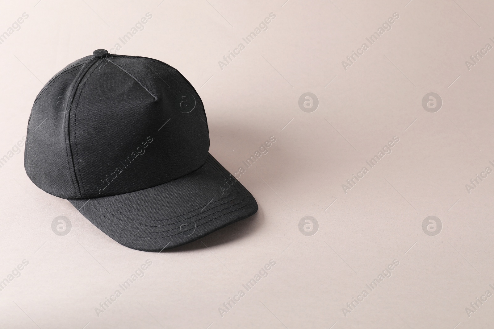 Photo of Stylish black baseball cap on light grey background. Mockup for design