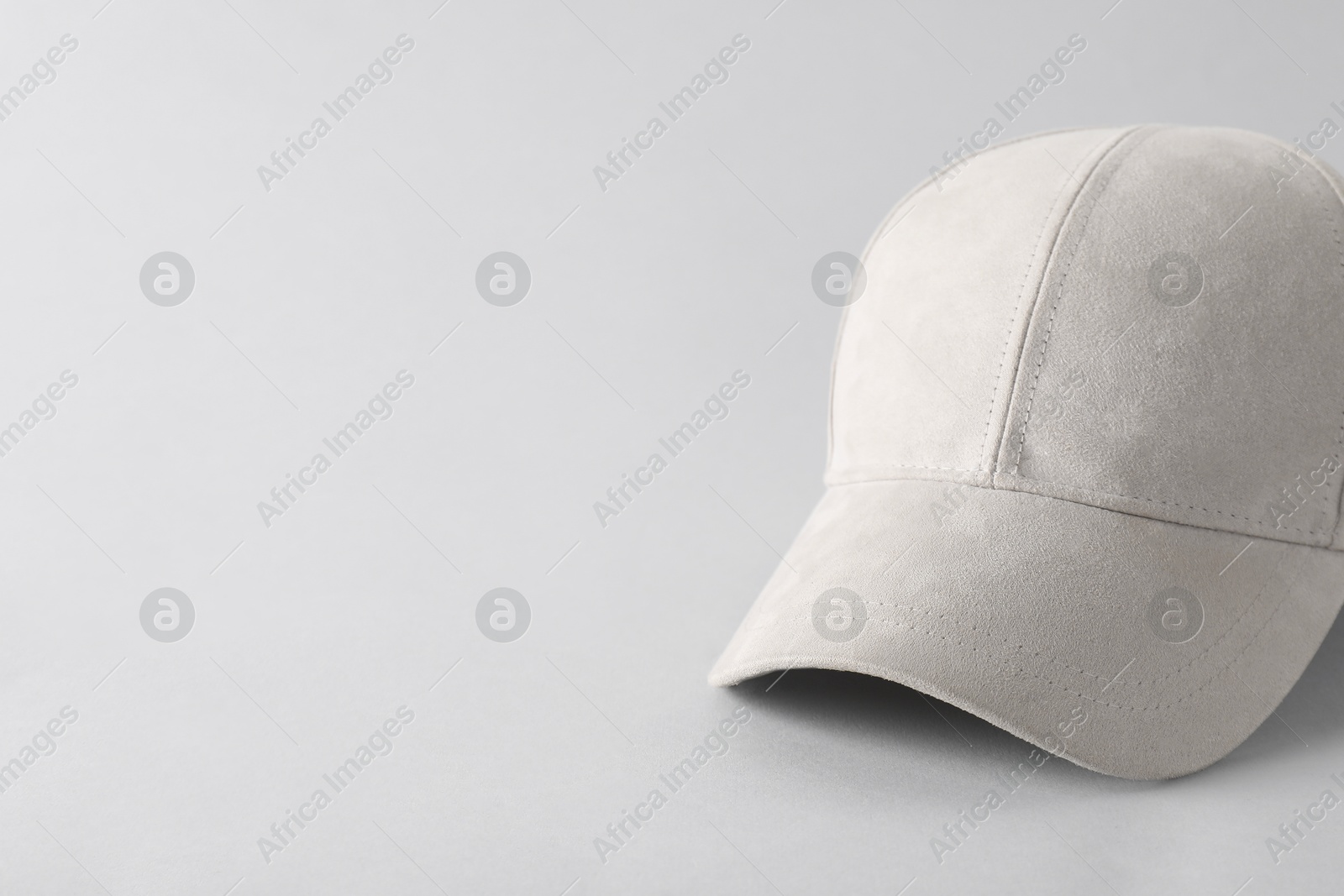 Photo of Stylish baseball cap on light grey background. Mockup for design