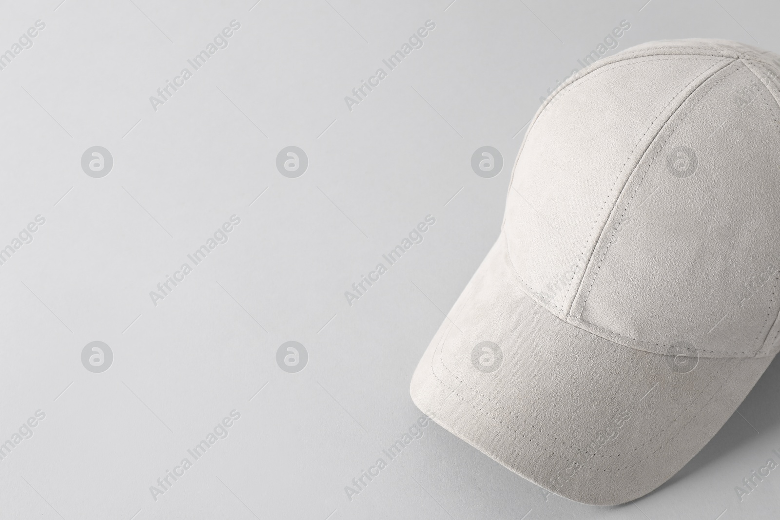 Photo of Stylish baseball cap on light grey background. Mockup for design