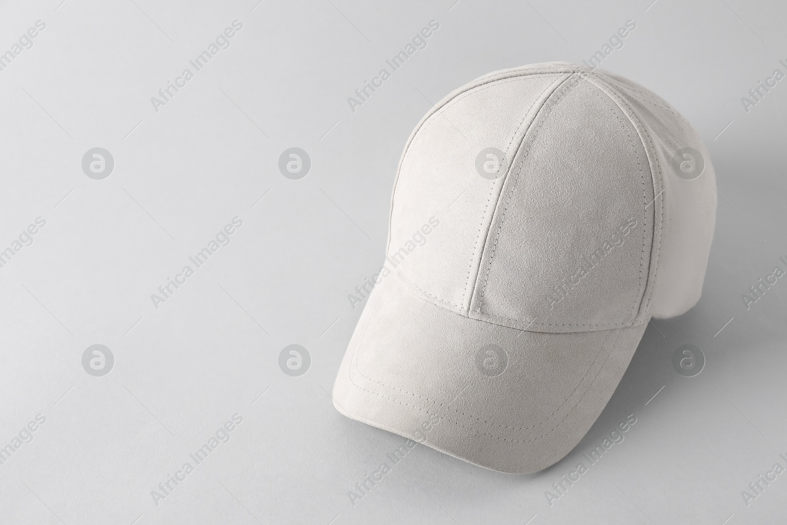 Photo of Stylish baseball cap on light grey background. Mockup for design