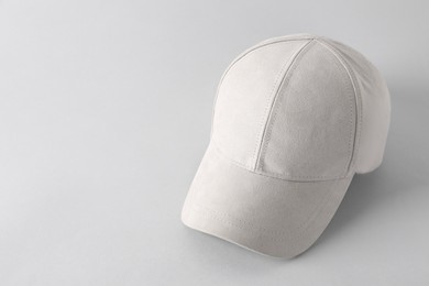 Photo of Stylish baseball cap on light grey background. Mockup for design