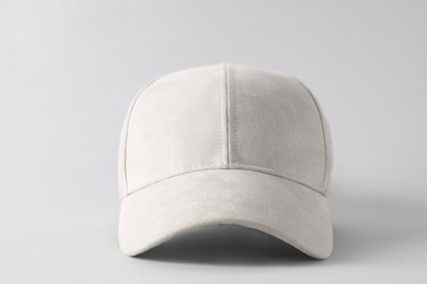 Photo of Stylish baseball cap on light grey background, closeup. Mockup for design