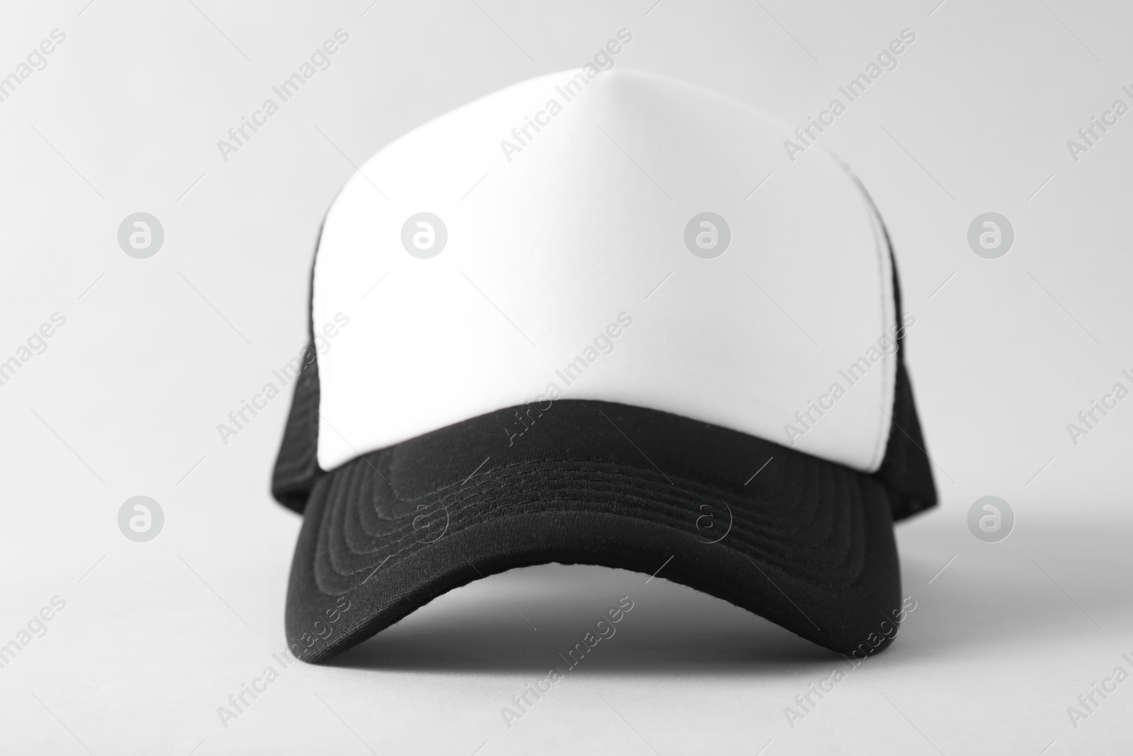 Photo of Stylish baseball cap on light grey background, closeup. Mockup for design