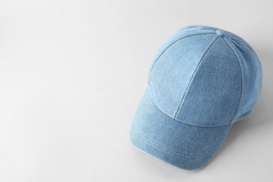 Photo of Stylish denim baseball cap on light grey background. Mockup for design