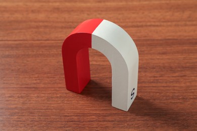 Photo of One color horseshoe magnet on wooden table