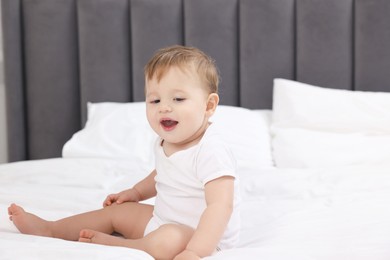 Photo of Cute little baby on bed at home