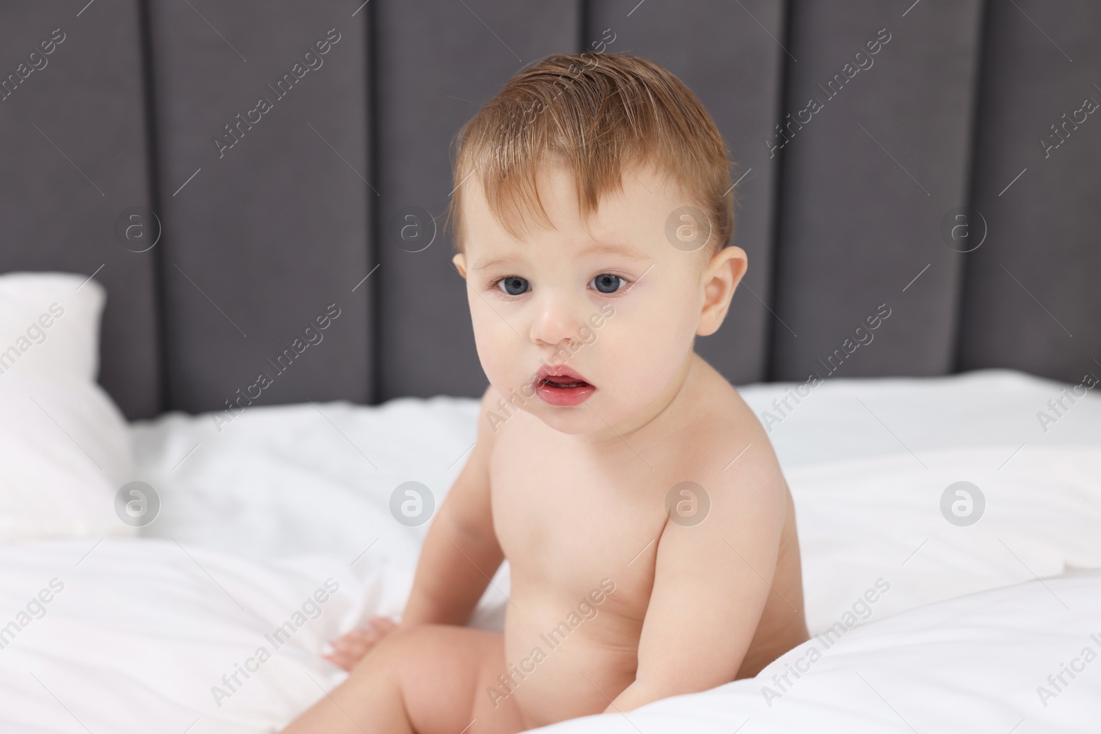 Photo of Cute little baby on bed at home