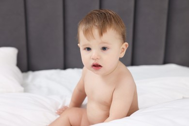 Photo of Cute little baby on bed at home