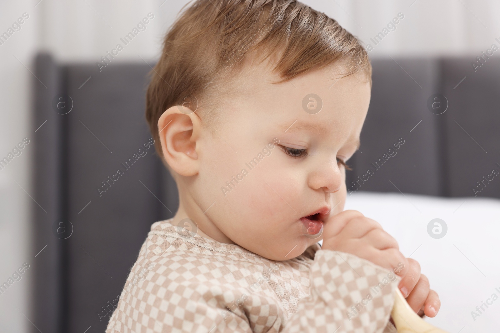 Photo of Sweet little baby on bed at home