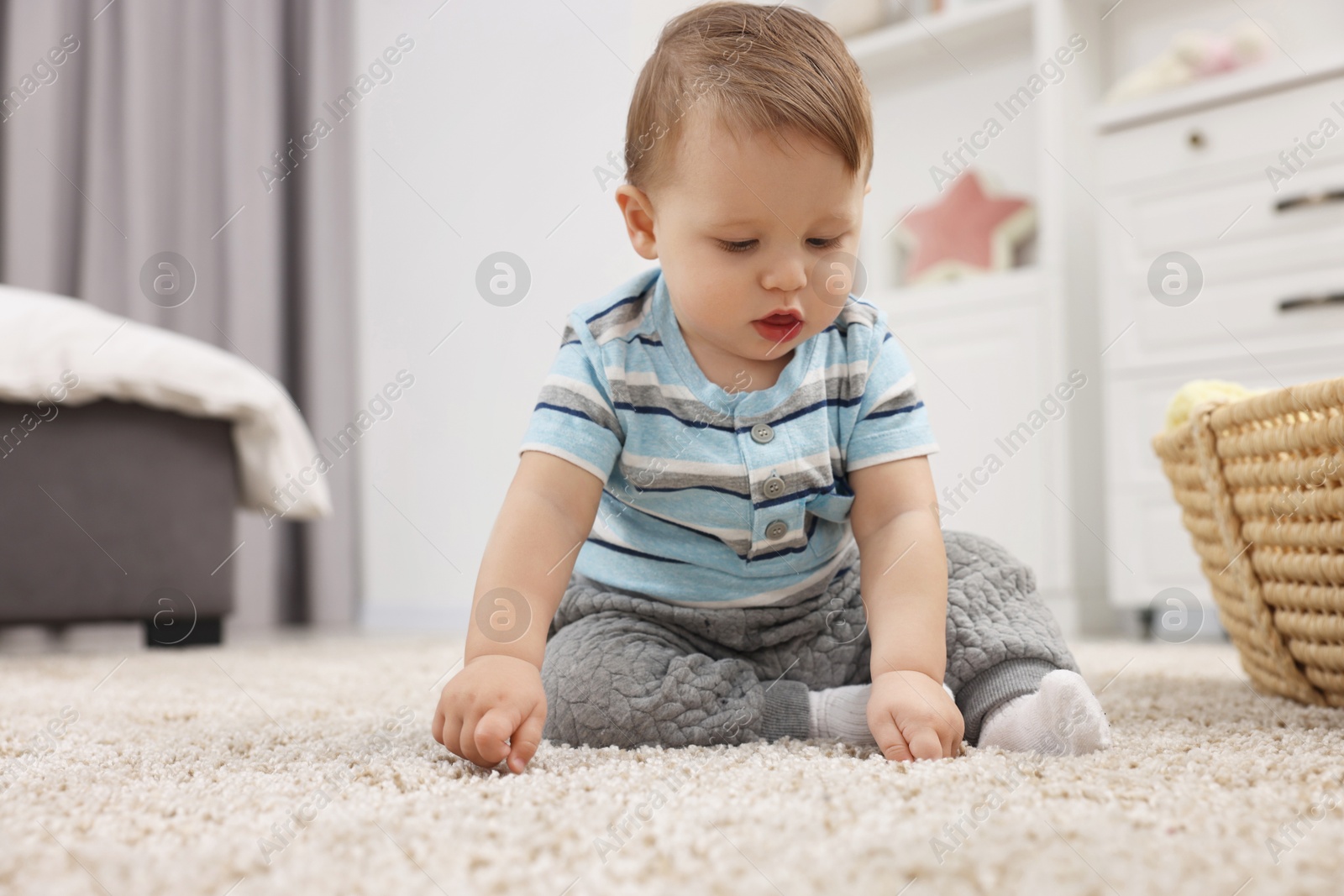 Photo of Adorable baby boy on floor at home